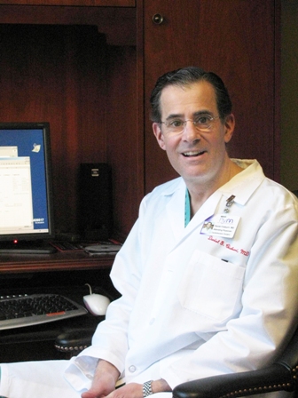 Photo of Dr. Richard Lazzaro sitting at a desk