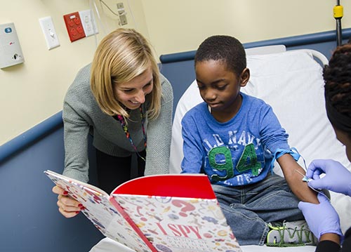 Gabrielle Marden with a patient in NYM's pediatric emergency room.