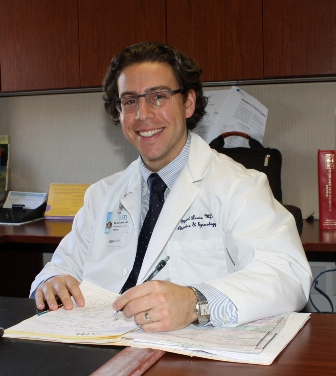 Photo of Dr. Lewis Copye at his desk
