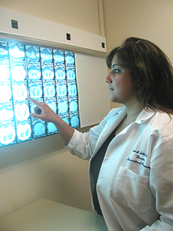 Dr. Sonali Sethi pointing at brain scans