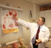 A doctor pointing to a diagram to explain something