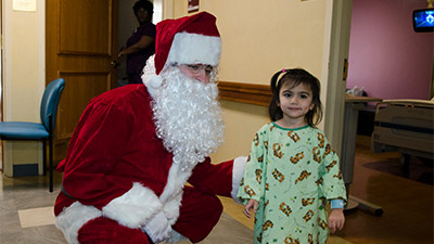 Santa visits with pediatric patient.