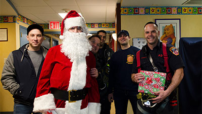 Santa and firefighters from Ladder Company 122, Engine Company 220 and Tower Ladder 131 visit children at NewYork-Presbyterian Brooklyn Methodist Hospital.