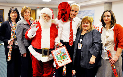 Santa claus posing for a photo with several healthcare professionals