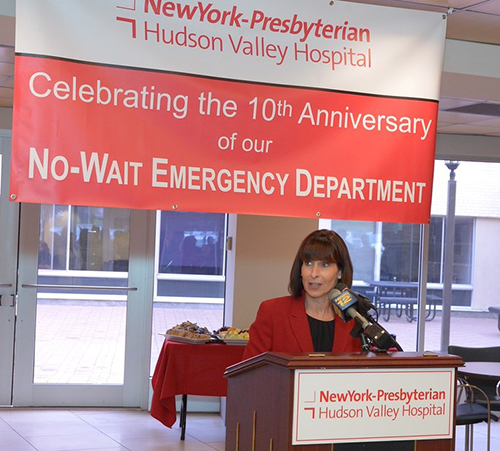 woman speaking at podium at NewYork-Presbyterian 20th anniversary of No-wait emergency department
