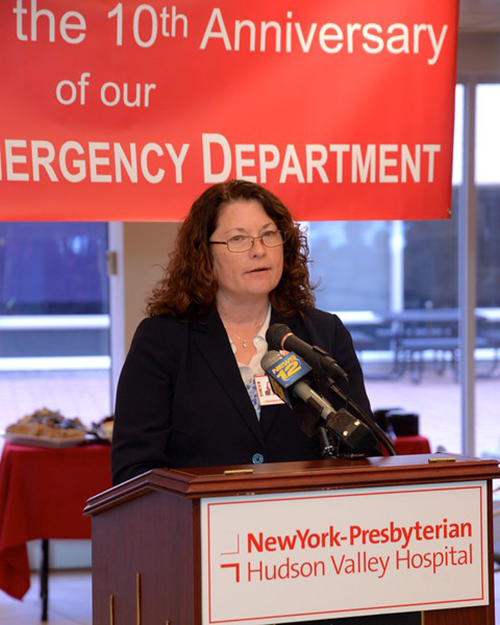 woman speaking at podium at NewYork-Presbyterian 20th anniversary of No-wait emergency department