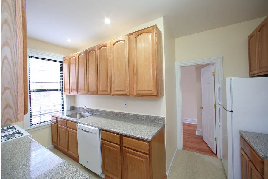 a kitchen with wooden cabinets at 245 Fort Washington