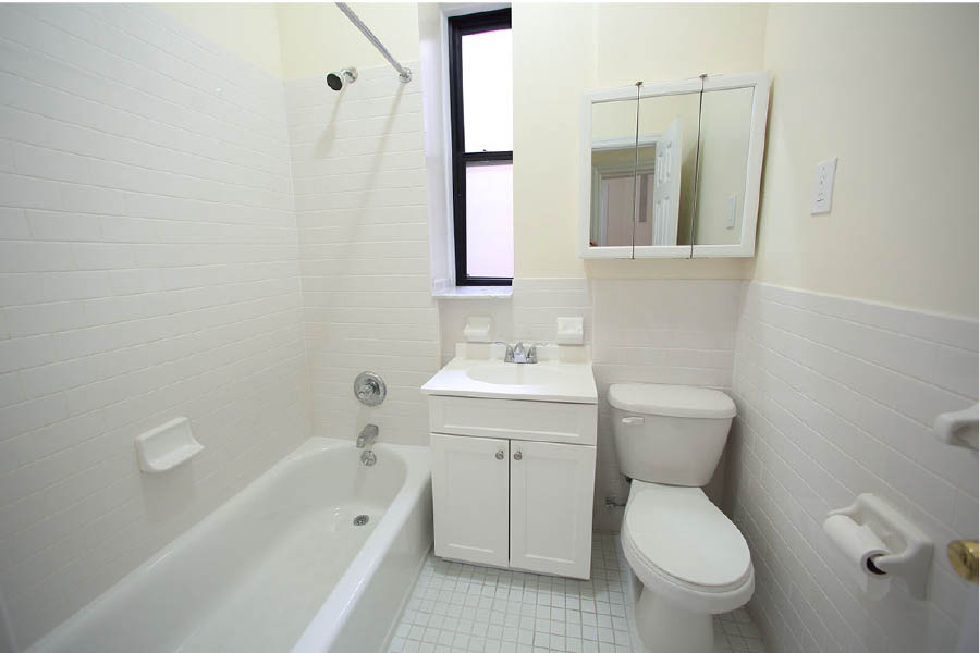 a bathroom with a tub toilet and sink at 600 West 169 Street