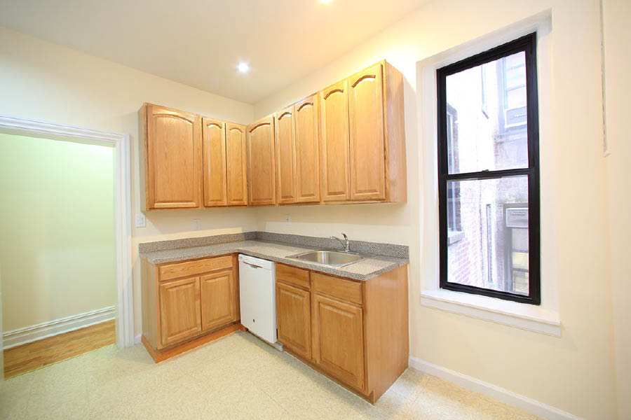 a kitchen with wooden cabinets at 600 West 169 Street