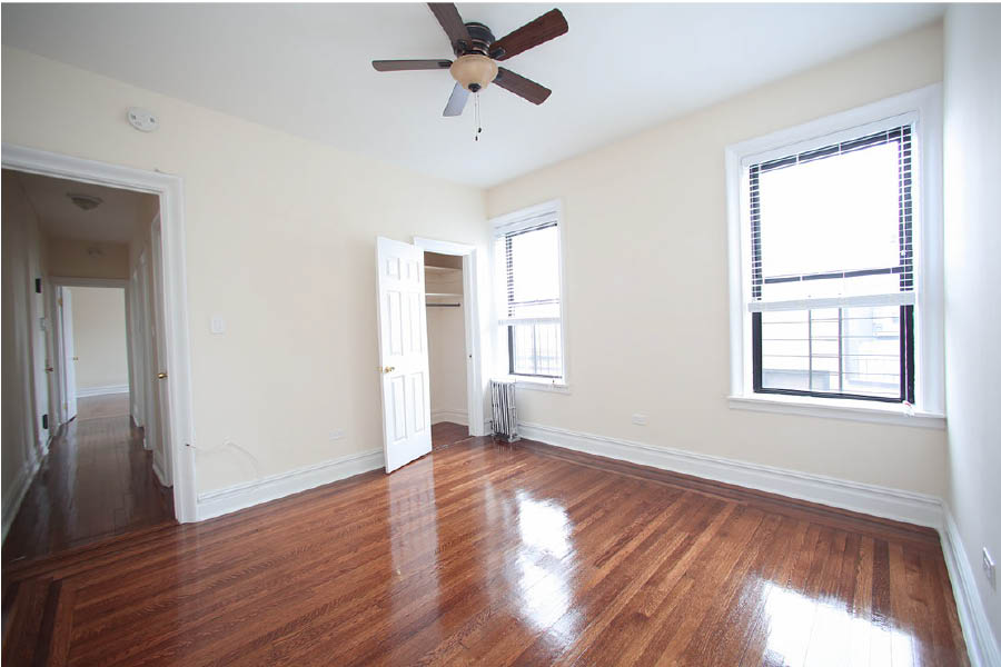 a room with a wood floor and a ceiling fan at 601 West 164 Street