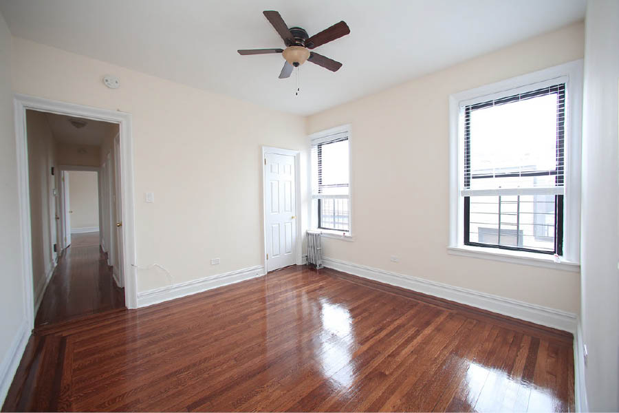 a room with a wood floor and a ceiling fan at 601 West 164 Street