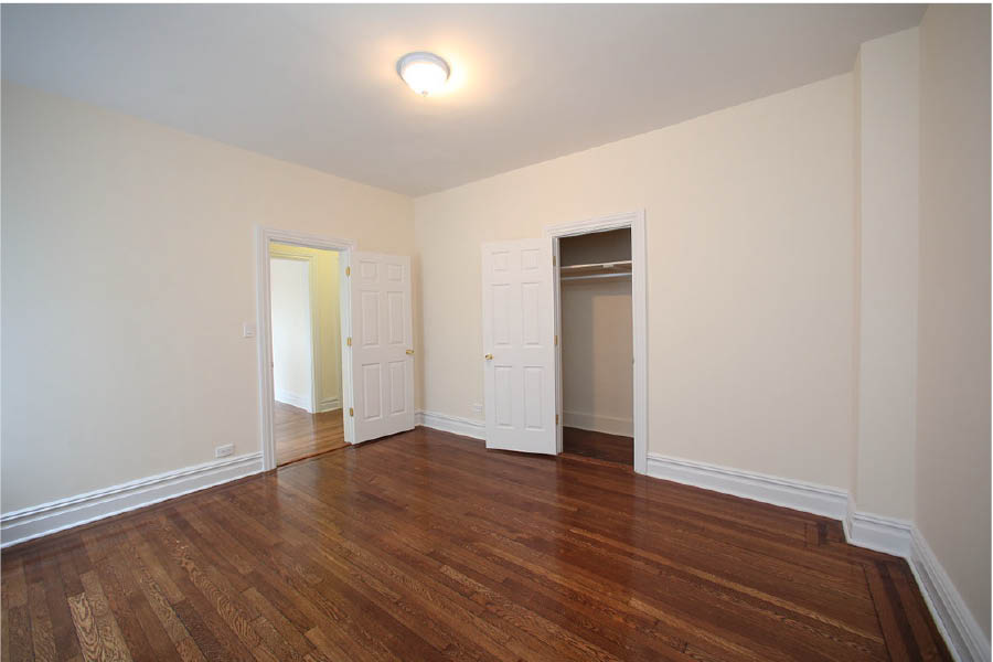 a room with white walls and wood floors at 625 West 169 Street