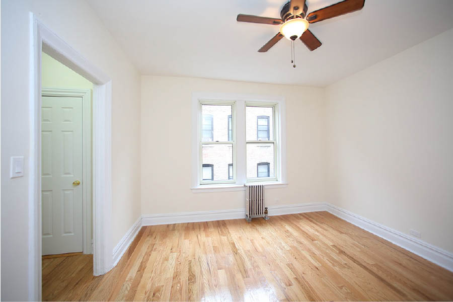 a room with a wood floor and a ceiling fan at 625 West 169 Street