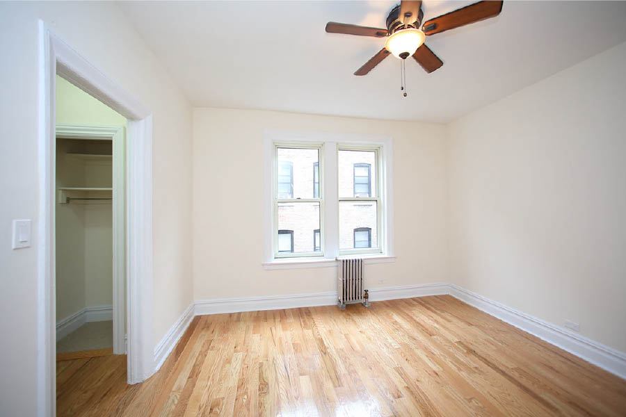 a room with a wood floor and a ceiling fan at 625 West 169 Street