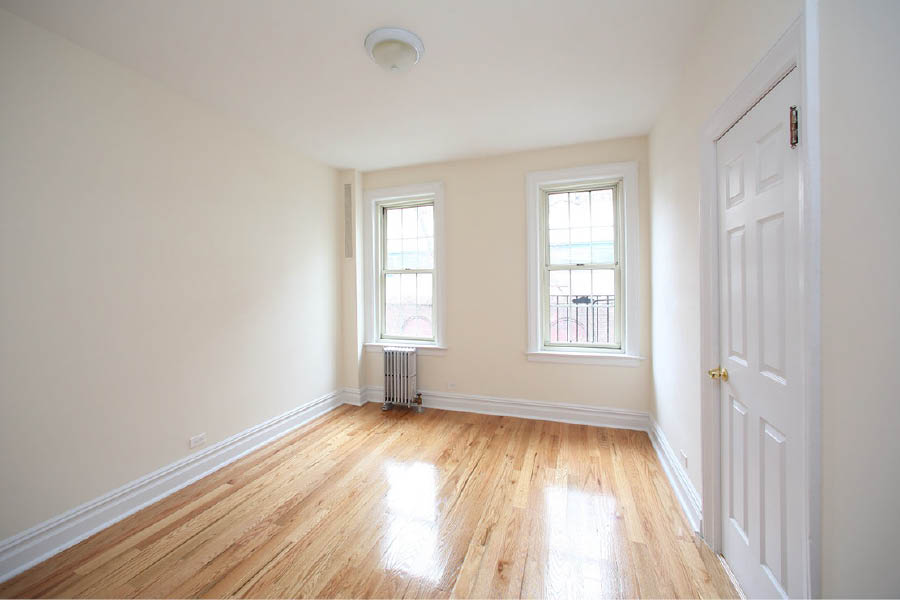 a room with a wood floor and white doors at 625 West 169 Street
