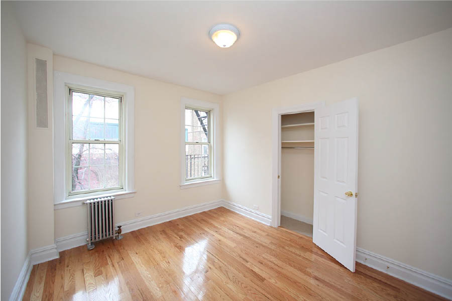 a room with a wood floor and closet at 625 West 169 Street