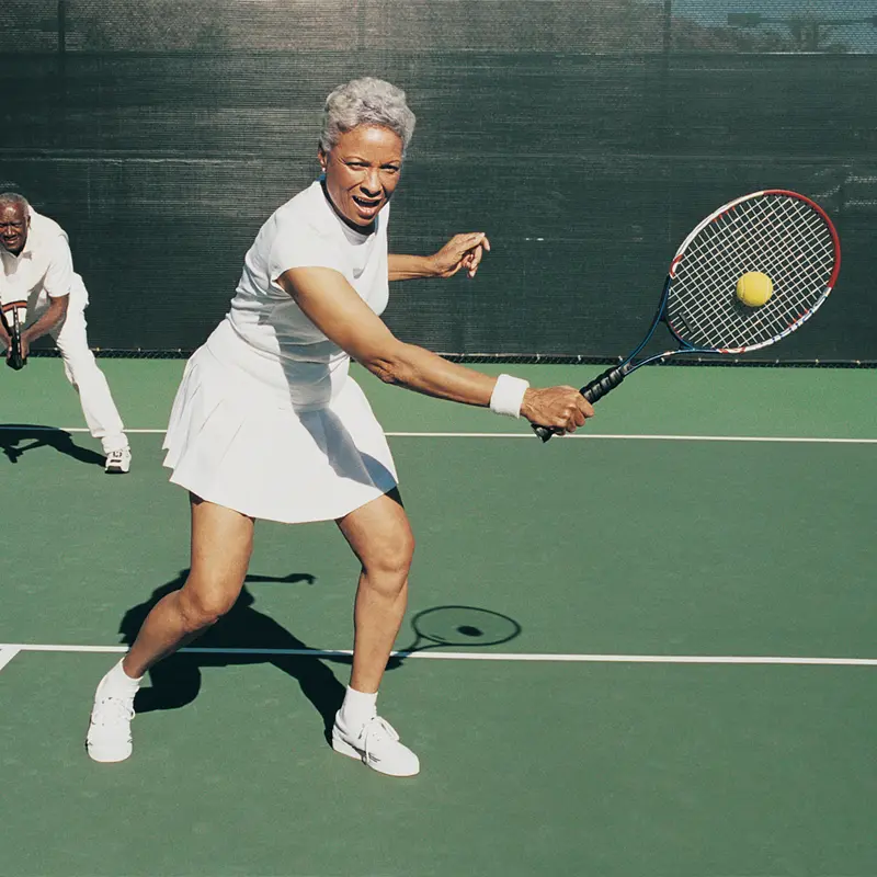 older lady playing tennis