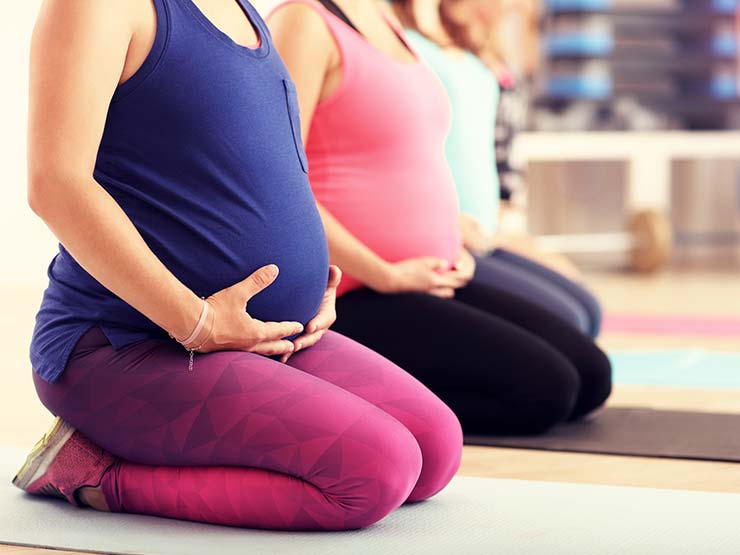 image of pregnant women doing yoga