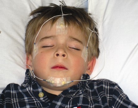 A child sleeping with detectors on his face