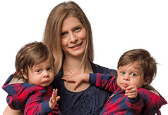 Celeste Fine with two little twins posing for the camera