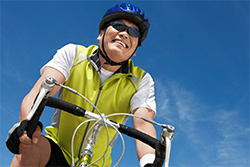 upshot of a cyclist wearing sunglasses for protection from sun