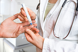 Doctor testing patient patient's glucose