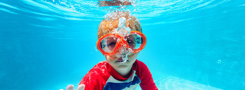 child wearing goggles in the water
