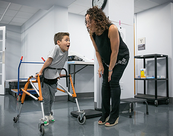 Dr. Jacqueline Montes with a 7-year-old patient with spinal muscular atrophy type 2