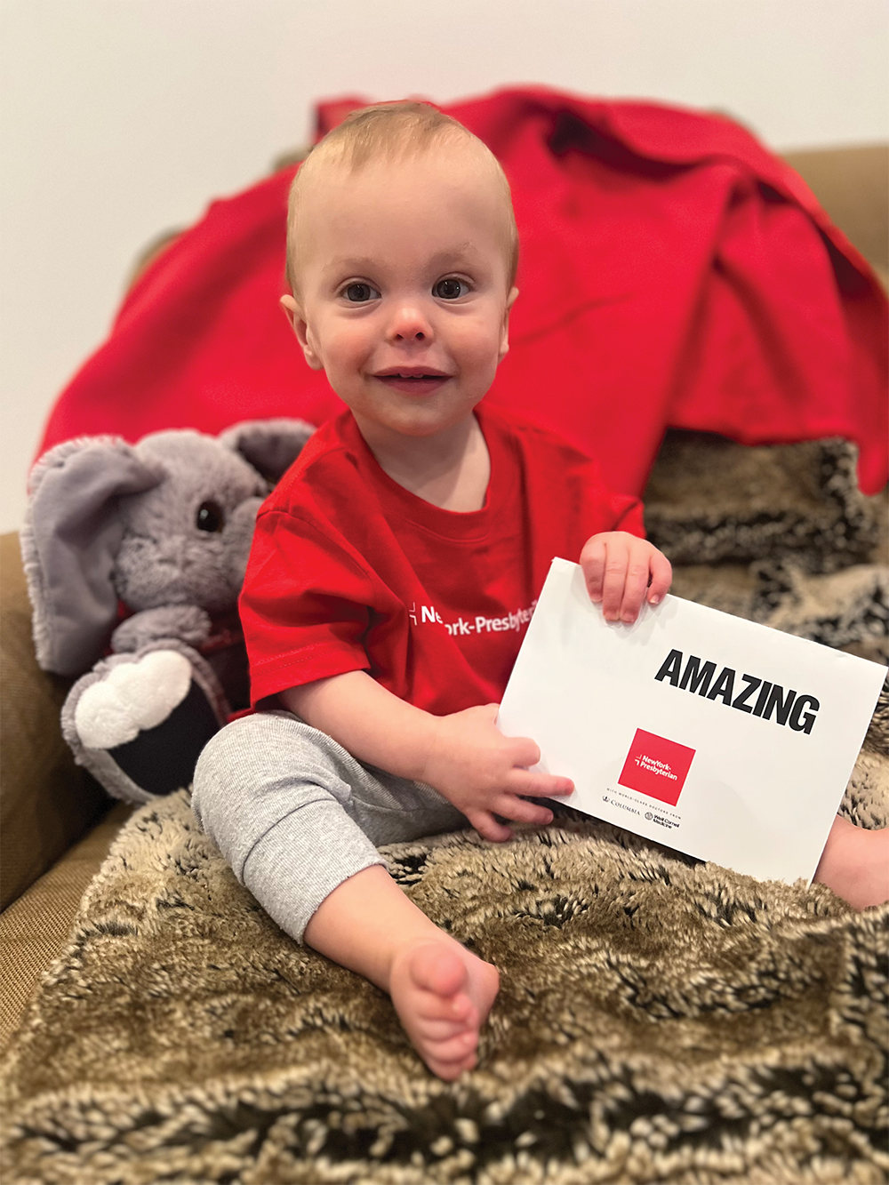 Baby sitting on a bed.
