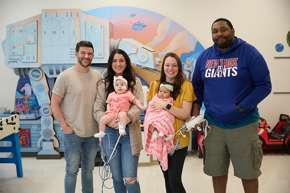 Group of smiling adults and children.