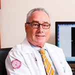 A man in a doctor's coat and tie.