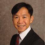 A smiling man in a suit.