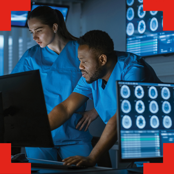 Technicians looking at a computer monitor.