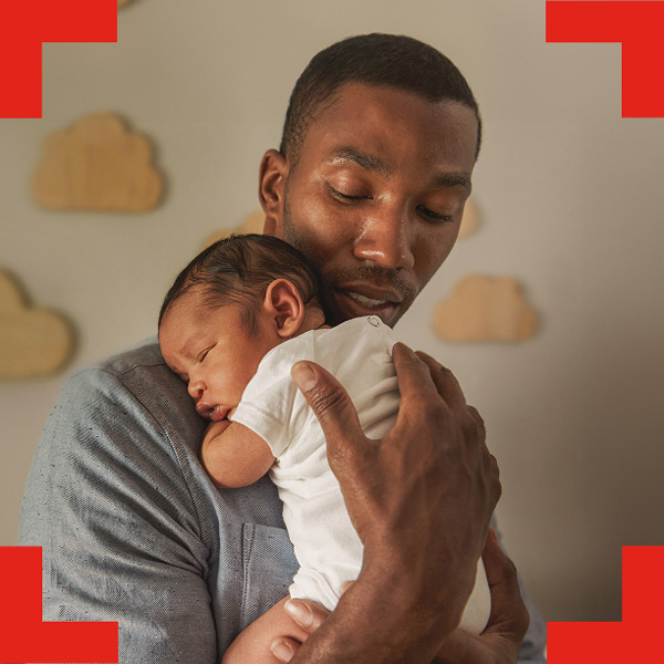 father holding sleeping baby