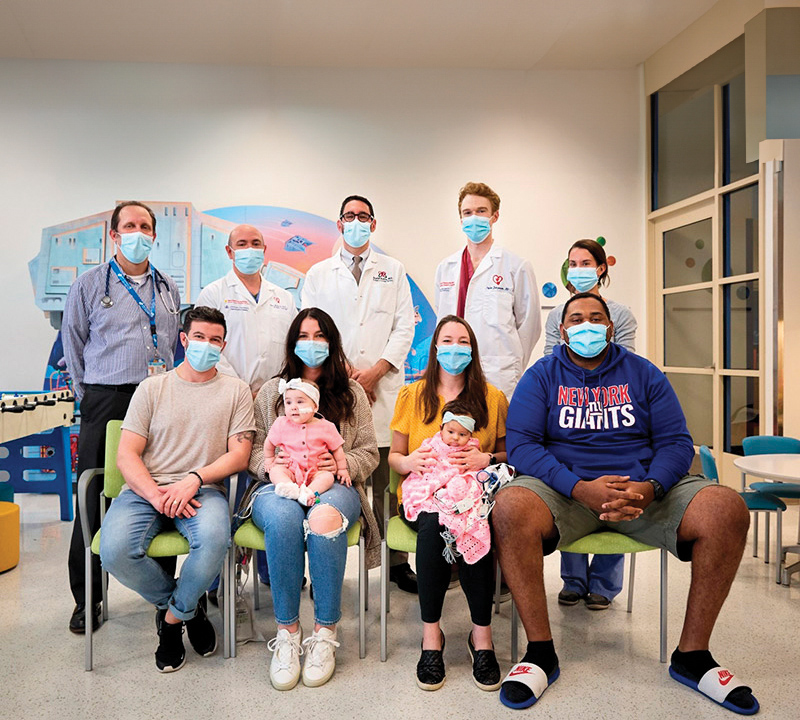 A group of people wearing masks, arranged in two rows