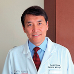 A man in a lab coat and tie.