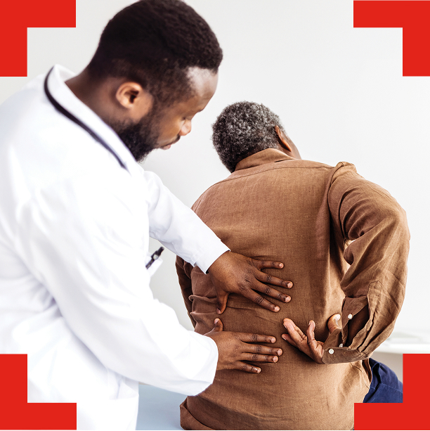 A doctor examining the back of an elderly individual.