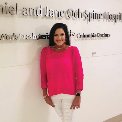 A woman in a hot pink sweater.