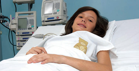a kid on the surgery bed looking at the camera