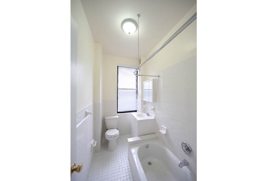 a bathroom with a tub toilet and sink at 245 Fort Washington