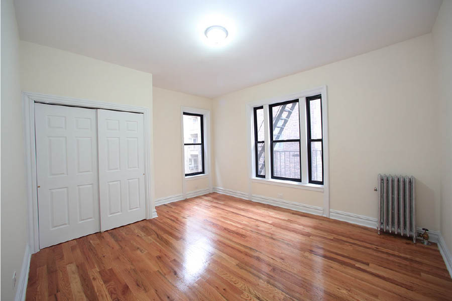 a room with a wood floor and white doors at 600 West 169 Street