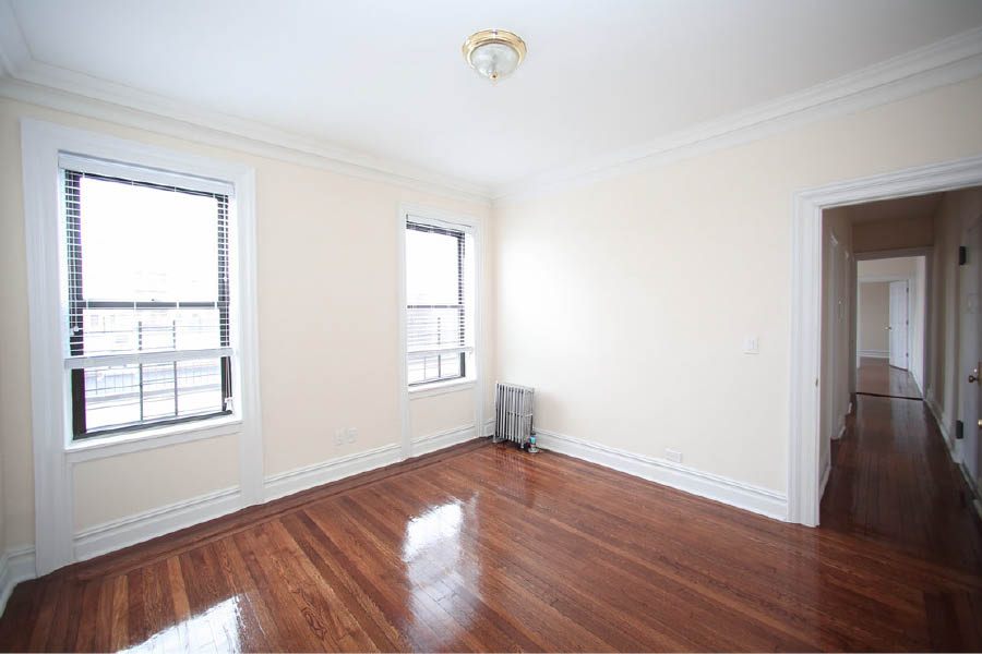 a room with a wood floor and window at 601 West 164 Street