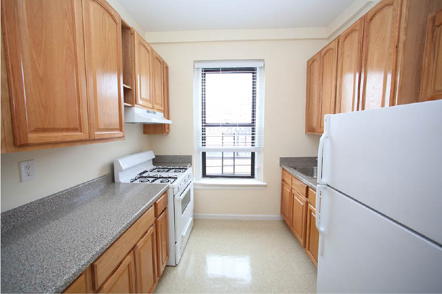 a kitchen with wooden cabinets at 601 West 164 Street