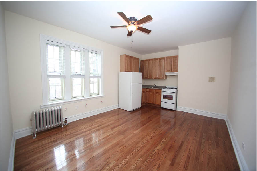 a kitchen with wooden cabinets at 625 West 169 Street