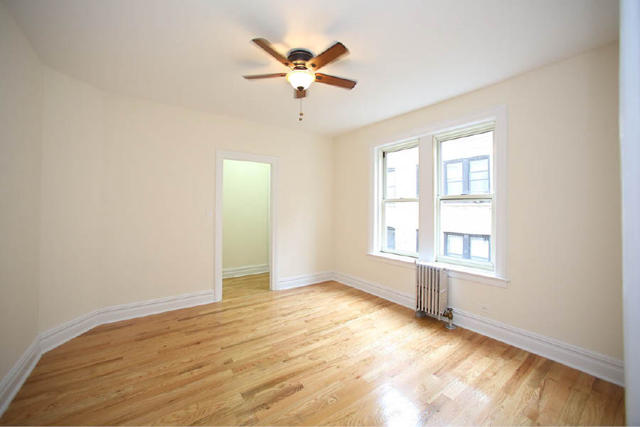 a room with a ceiling fan and a wood floor at 625 West 169 Street