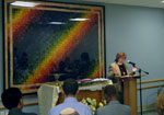 a person standing at a podium in front of a group of people