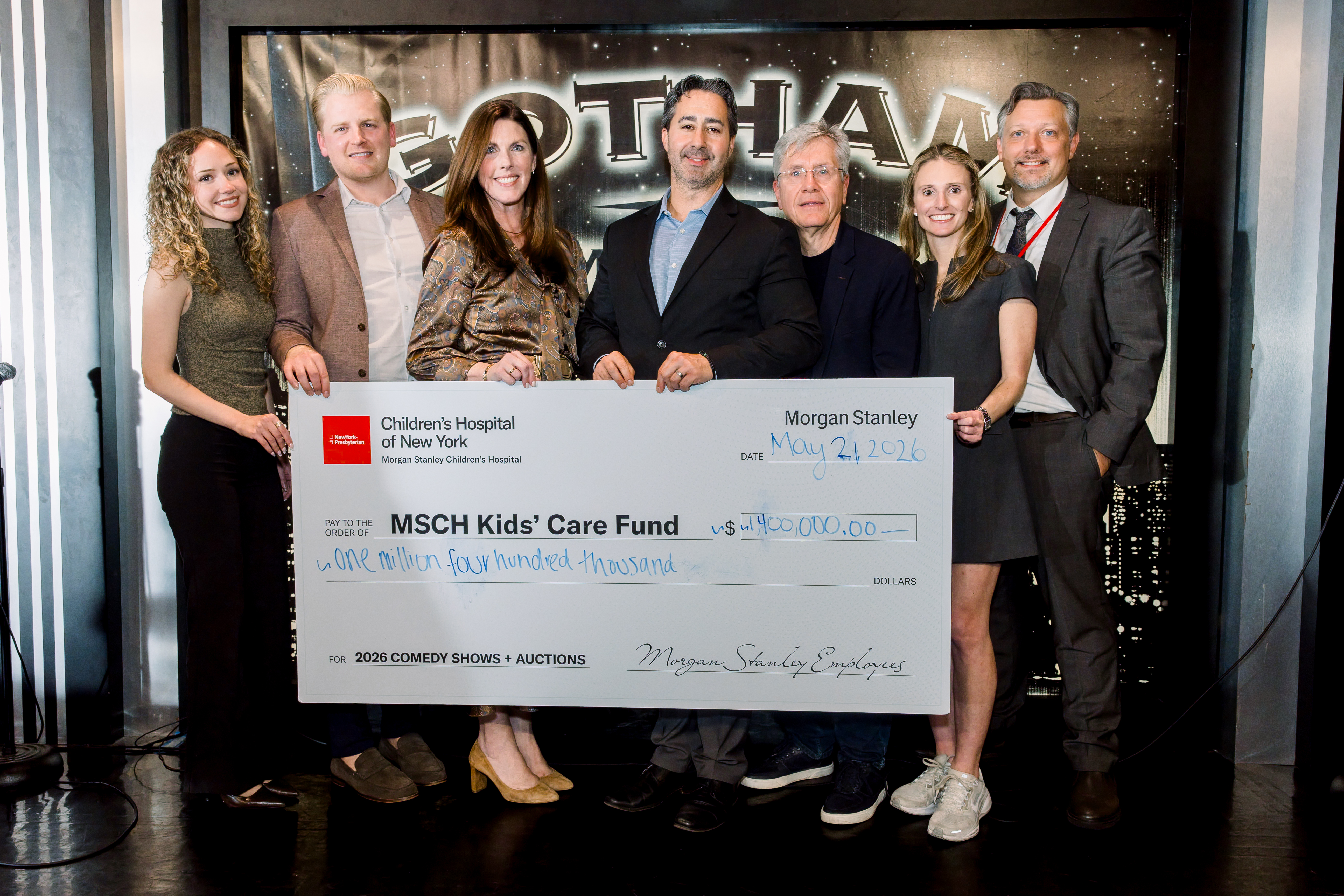 Drew Ertman and members of NYP's Office Development pose with a check.