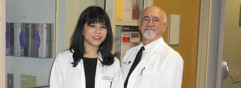 Two doctors standing next to each other for a photo
