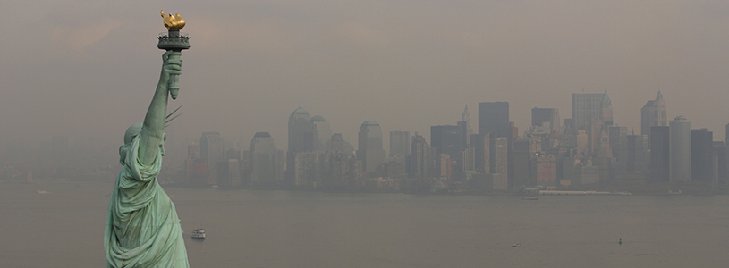 The statue of liberty with new york skyline in the background