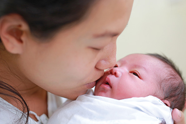 lady kissing a newly born